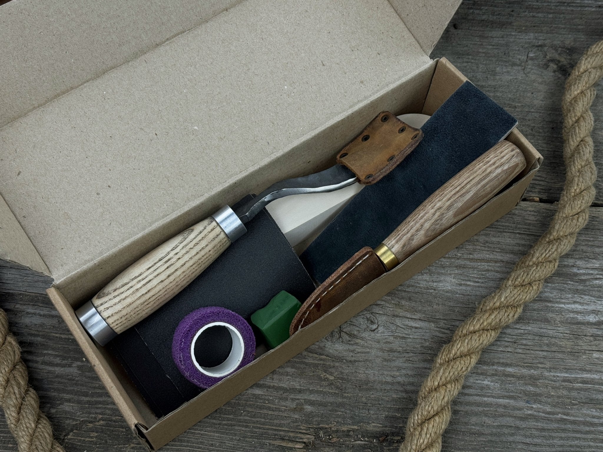 The Perfect Spoon Carving Kit for Beginners with tools, wooden blank, sandpaper, and sharpening board