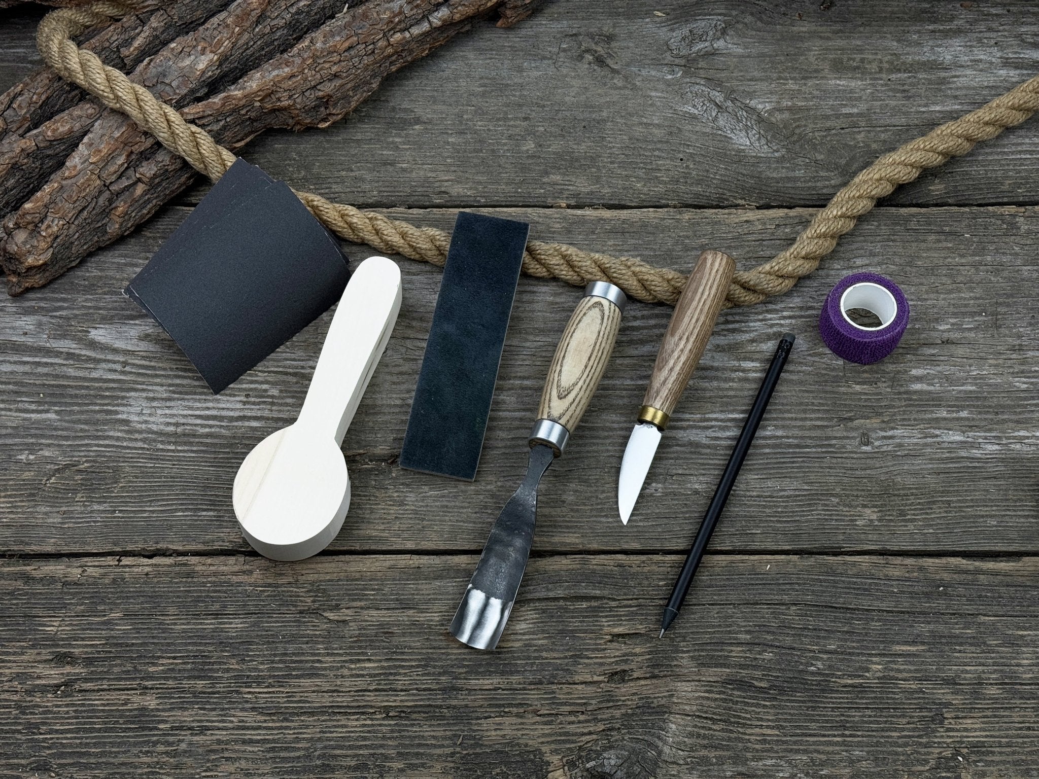 The Perfect Spoon Carving Kit for Beginners with tools, wooden blank, sandpaper, and sharpening board