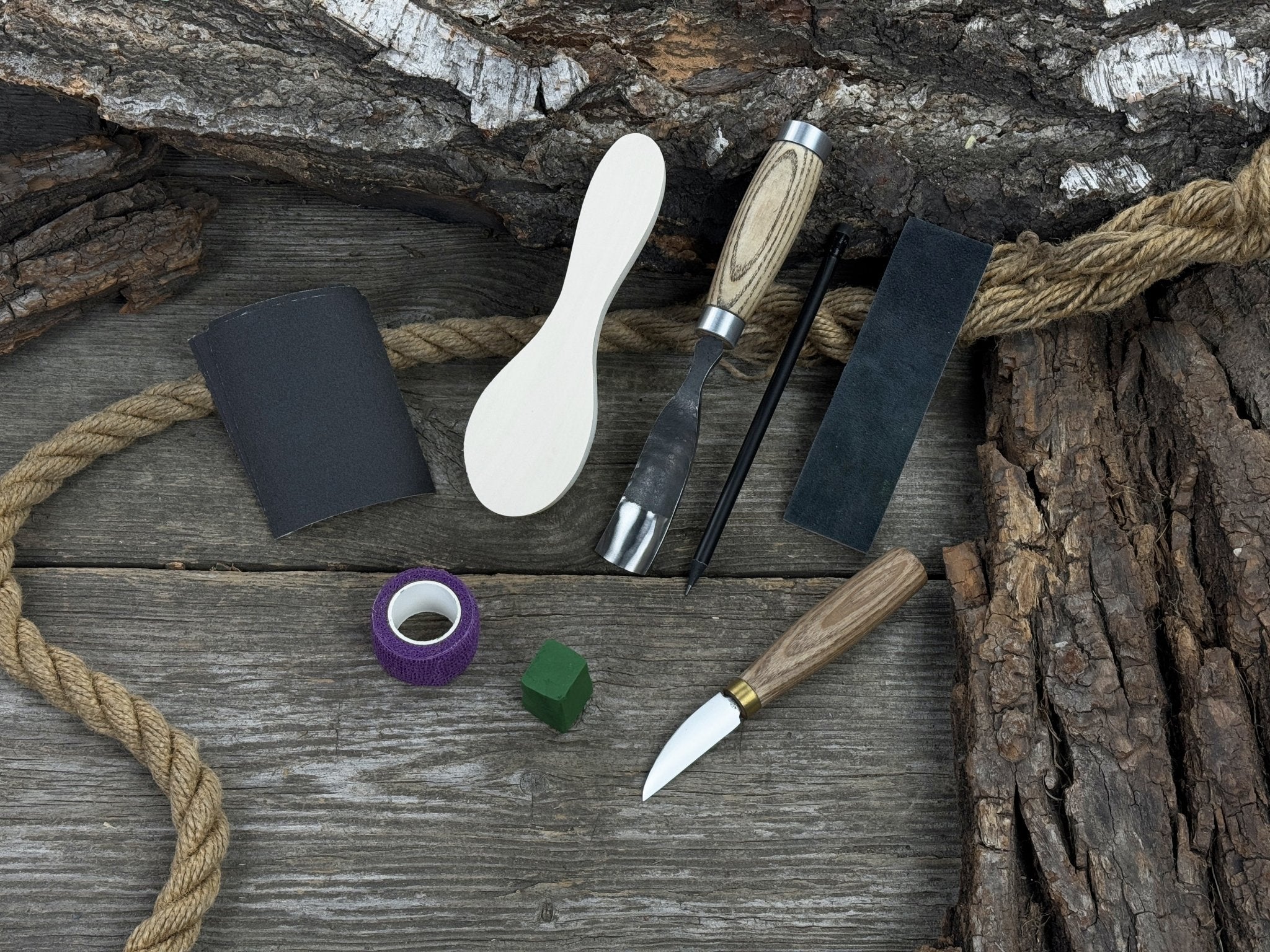 The Ultimate Beginner’s Spoon Carving Kit with tools, wooden blank, sandpaper, and sharpening board