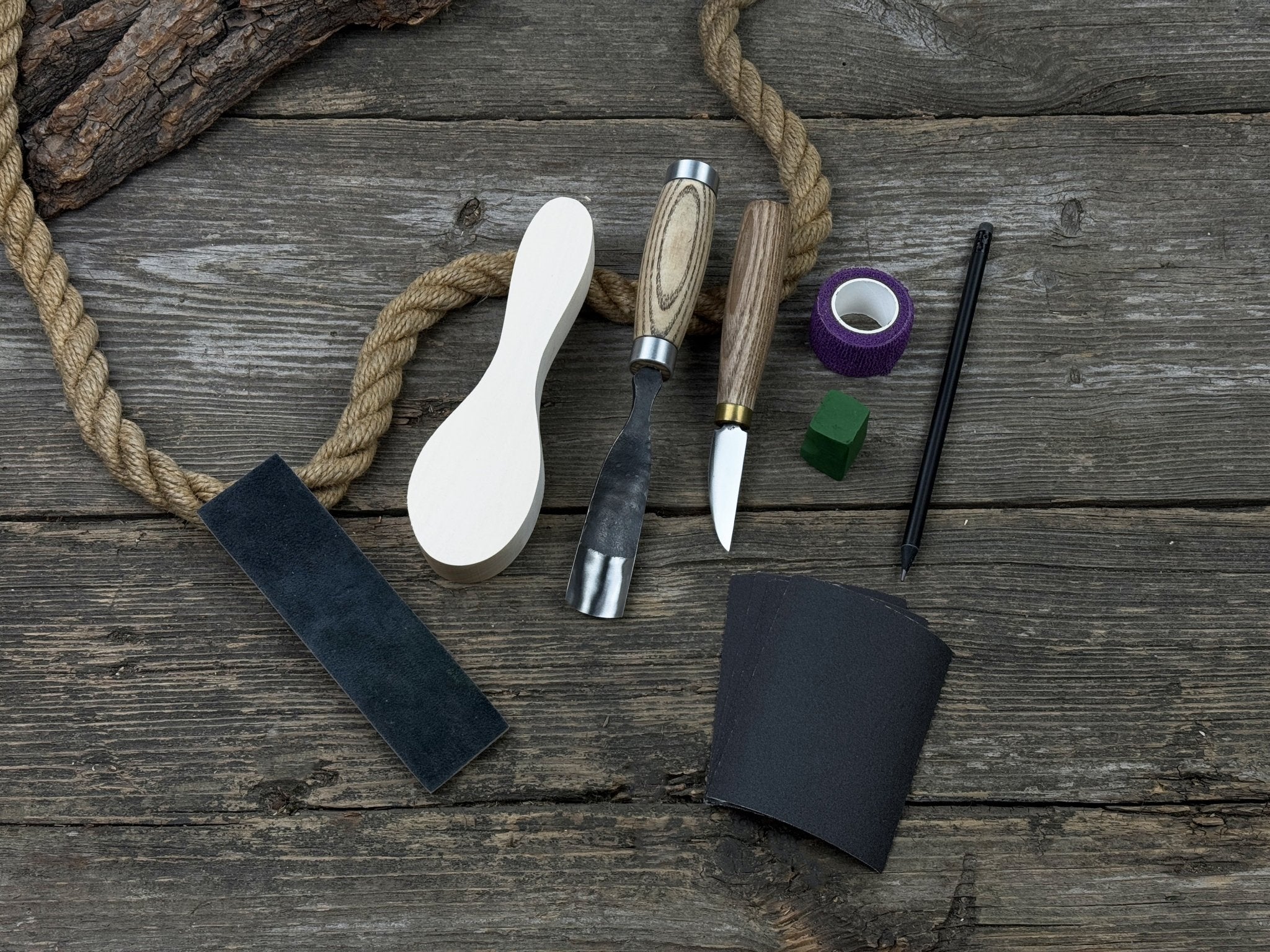 The Ultimate Beginner’s Spoon Carving Kit with tools, wooden blank, sandpaper, and sharpening board