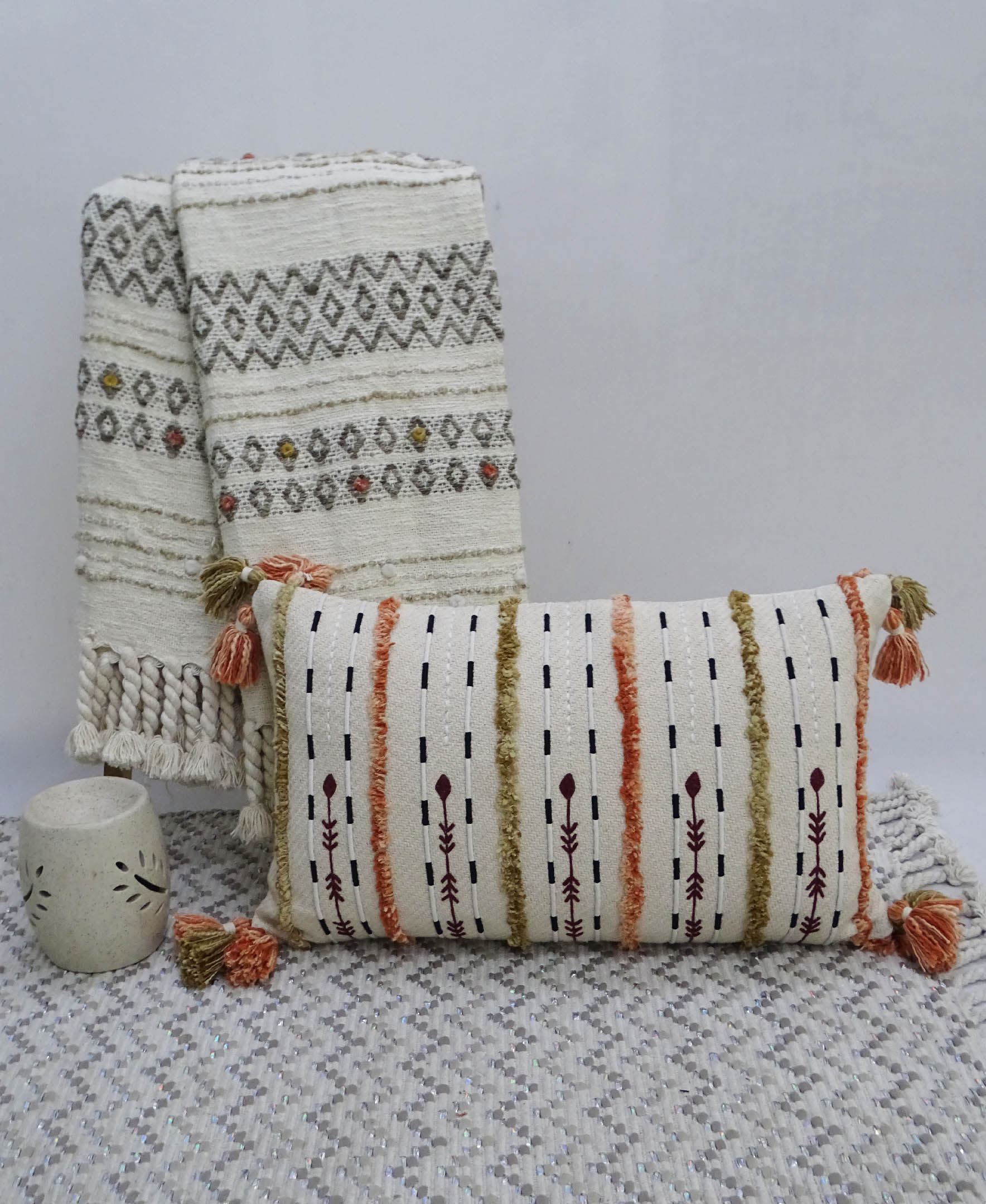 Colorful handwoven throw pillow with fringes on a sofa