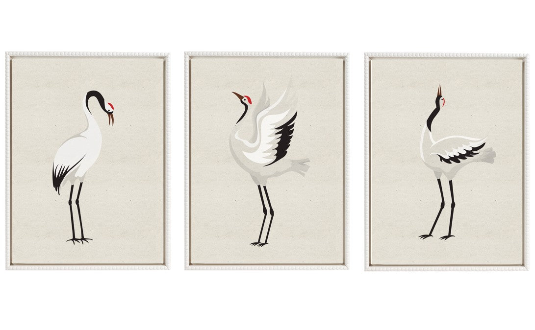 Three framed canvas art pieces depicting minimalist Japanese cranes with red crowns, arranged side by side on a neutral wall.