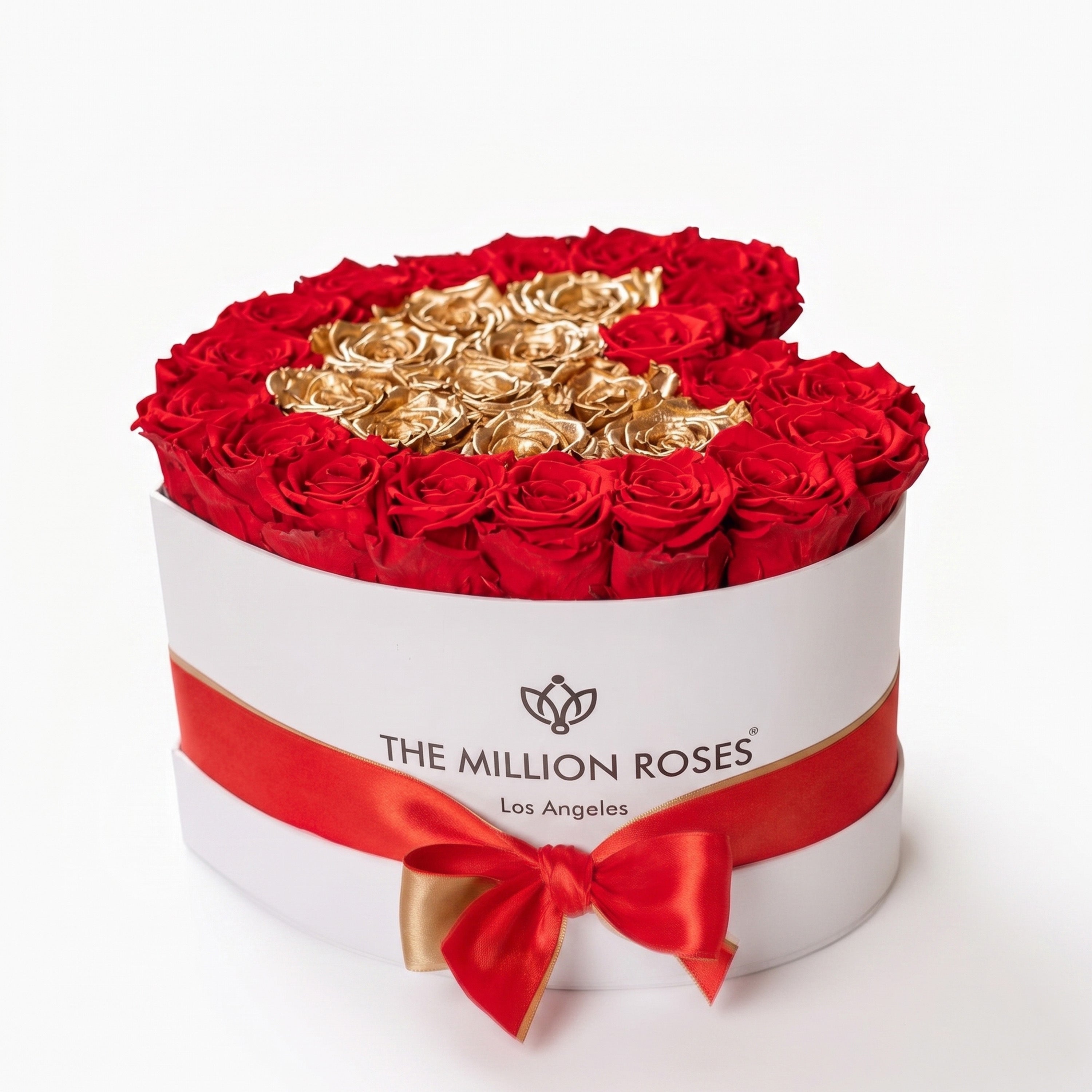 White heart-shaped box filled with red and gold roses from The Million Roses