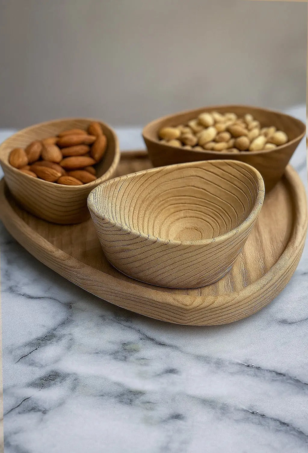 Set of handcrafted wooden nut bowls with tray showing natural wood grain and sandblasted texture
