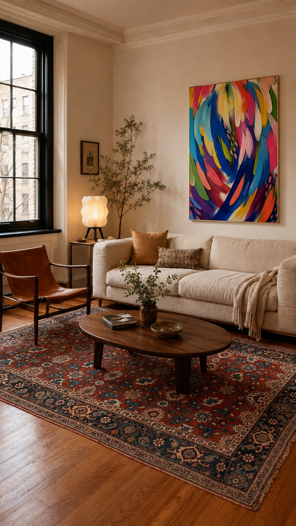 Mixed-style living room with antique Persian rug, colorful art and sculptural lamp