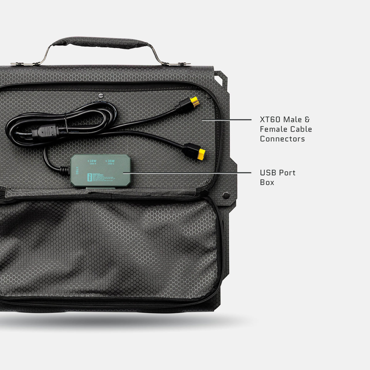 Black carrying case with a gray textured panel containing a black USB port box and XT60 male and female cable connectors with yellow tips, shown from above.