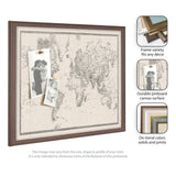 Framed pinboard with vintage-style black and white world map printed on textured fabric, displaying two black-and-white photos pinned at the upper left section.