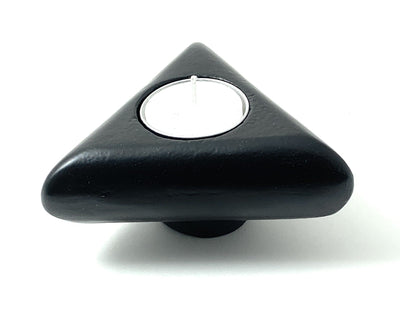 Vibhsa Unique Candle Holder in rustic black finish holding a taper candle and a tealight candle on a wooden surface