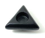 Black triangular candle holder with rounded corners and a circular cavity at the center, shown from above on a white background.