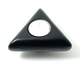 Black triangular candle holder with smooth rounded corners holding a small white tealight candle, shown from above on a white background.