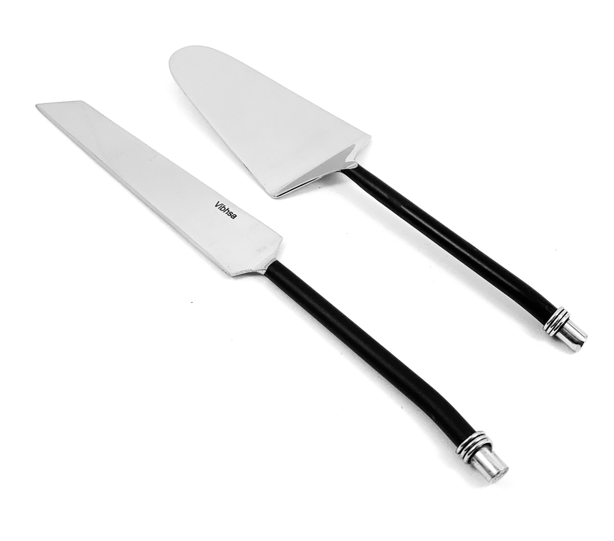 Cake cutting and serving set with black twisted handled knife and server on wooden surface