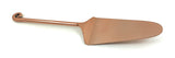 Copper-finished cake server with a flat, pointed blade and a long handle ending in a spiral curl.