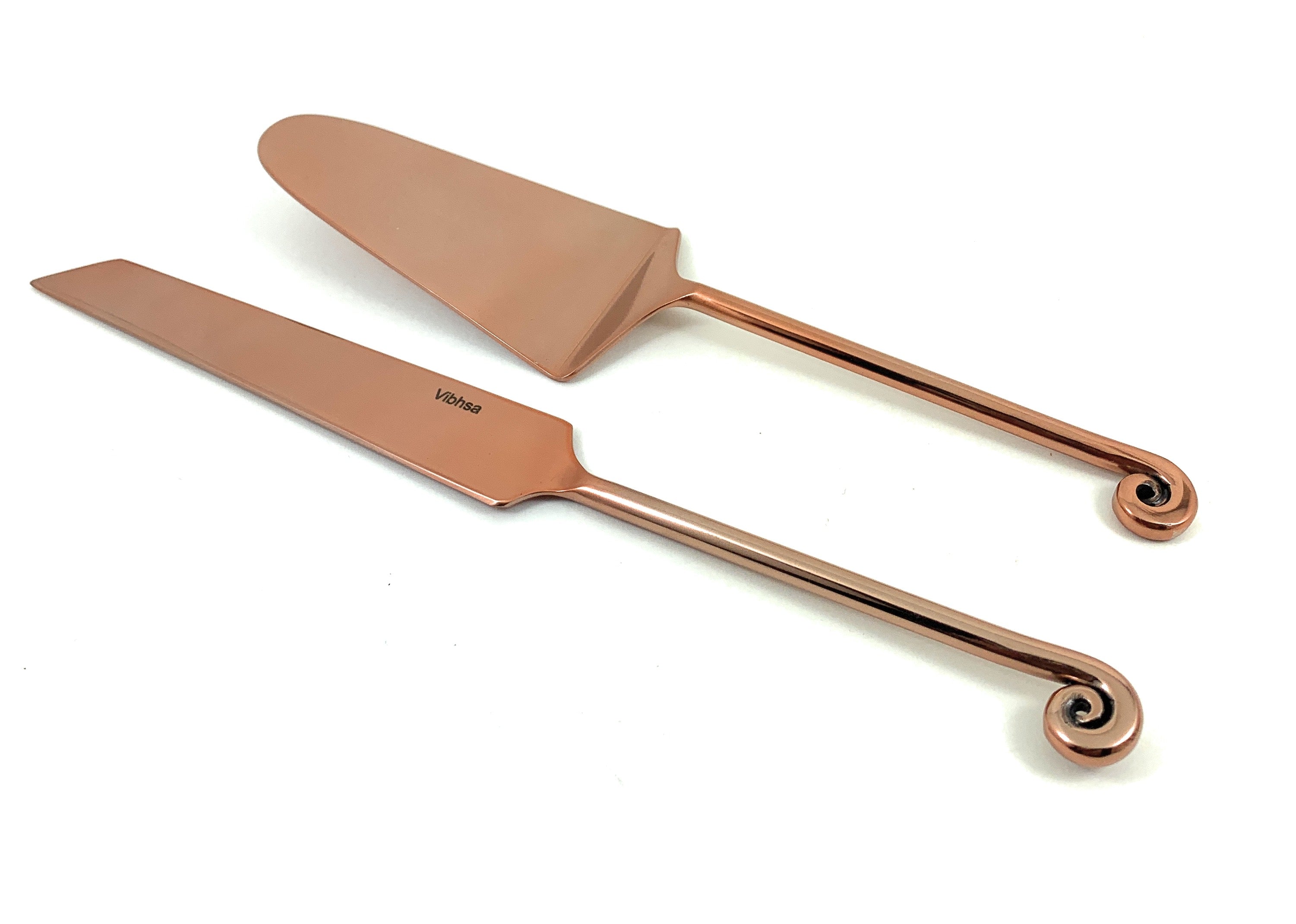 Vibhsa Designer Cake Serving Set with copper-finished handles on a table