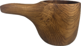 Smooth teak kuksa mug with integrated handle and natural wood grain patterns, featuring an open top and a hanging hole in the handle.