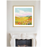 Colorful framed landscape painting of a meadow with pink and red flowers in the foreground, green rolling hills, and a blue sky with white clouds.