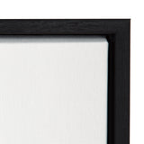 Close-up of a black wooden frame surrounding a white stretched canvas corner with visible texture and fabric weave.