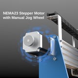 Close-up of a silver NEMA23 stepper motor with a round manual jog wheel mounted on a blue and aluminum CNC router frame, against a gray gradient background.