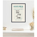 Framed canvas print resembling a guest check with teal and black text reading 'Take it ONE DAY at a TIME' hung on a white wall above a minimalistic white shelf with dried plants and small containers.