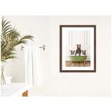 Framed print of three bear cubs standing in a green clawfoot bathtub against white paneled wall, displayed in a bright bathroom with a white towel and green plant.