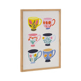 Framed print featuring six colorful coffee cups decorated with floral and leaf patterns in yellow, pink, red, blue, and black accents on a white background.