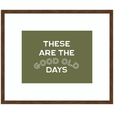 Framed wall art print titled 'These Are the Good Old Days' with stamped sage green lettering in a Carlisle Brown Narrow frame