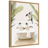 Framed canvas art showing penguins relaxing in a palm bathtub, by Amy Peterson