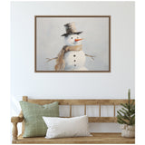Painting of a snowman with a gray top hat, a tan scarf, stick arms, and black buttons, framed and hung above a wooden bench with green and white pillows and a small potted pine tree.