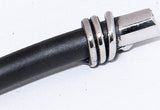 Close-up of a black butter spreader handle with three shiny silver metal rings near the polished silver metal end cap.