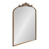 Rectangular mirror with an arched top and an ornate gold-colored decorative crest featuring floral motifs at the center of the arch.