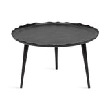 Round black coffee table with a subtly wavy scalloped edge and three tapered legs, shown on a white background.