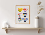 Framed print of six colorful coffee cups with floral patterns arranged in two columns, displayed above a wooden shelf with white vases and dried pampas grass.