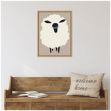 Framed minimalist canvas of a white sheep with black face and legs on a light beige background, hung above a rustic wooden bench with an open book and a "welcome home" pillow.