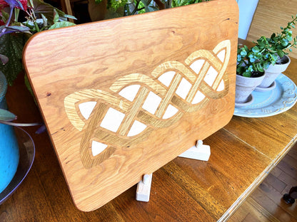 Cherry wood charcuterie board with white oak and maple Celtic knot inlay by Fitzgerald Custom Woodcraft