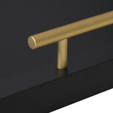 Close-up of a gold metal cylindrical handle attached perpendicularly to a flat black rectangular base, set against a dark background.