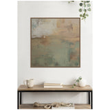Abstract canvas wall art in muted sage green, beige, and brown tones with textured brushstrokes, framed and hanging above a wooden table with neutral decor.