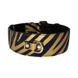 Black and gold zebra-striped leather collar with a gold D-ring and buckle hardware, shown at an angle against a white background.