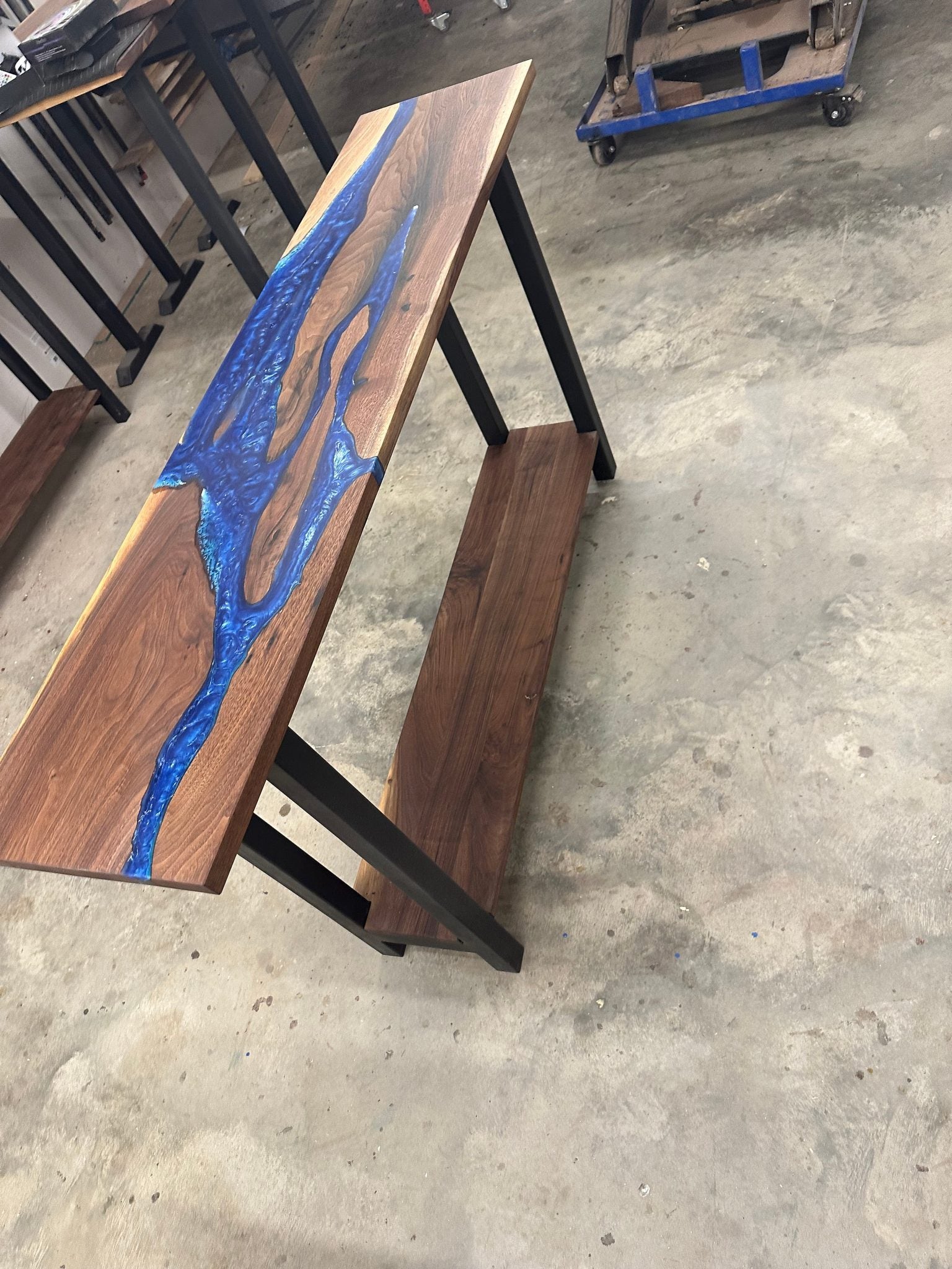 Walnut river console table made with black walnut slabs and blue ocean epoxy