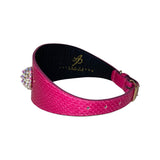 Wide fuchsia snake-pattern leather collar with three custom Swarovski crystal rivets and a gold buckle, shown on a white background.