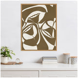Abstract framed canvas featuring large organic shapes in olive green and white, hanging above a white desk with books, potted plant, and patterned containers.
