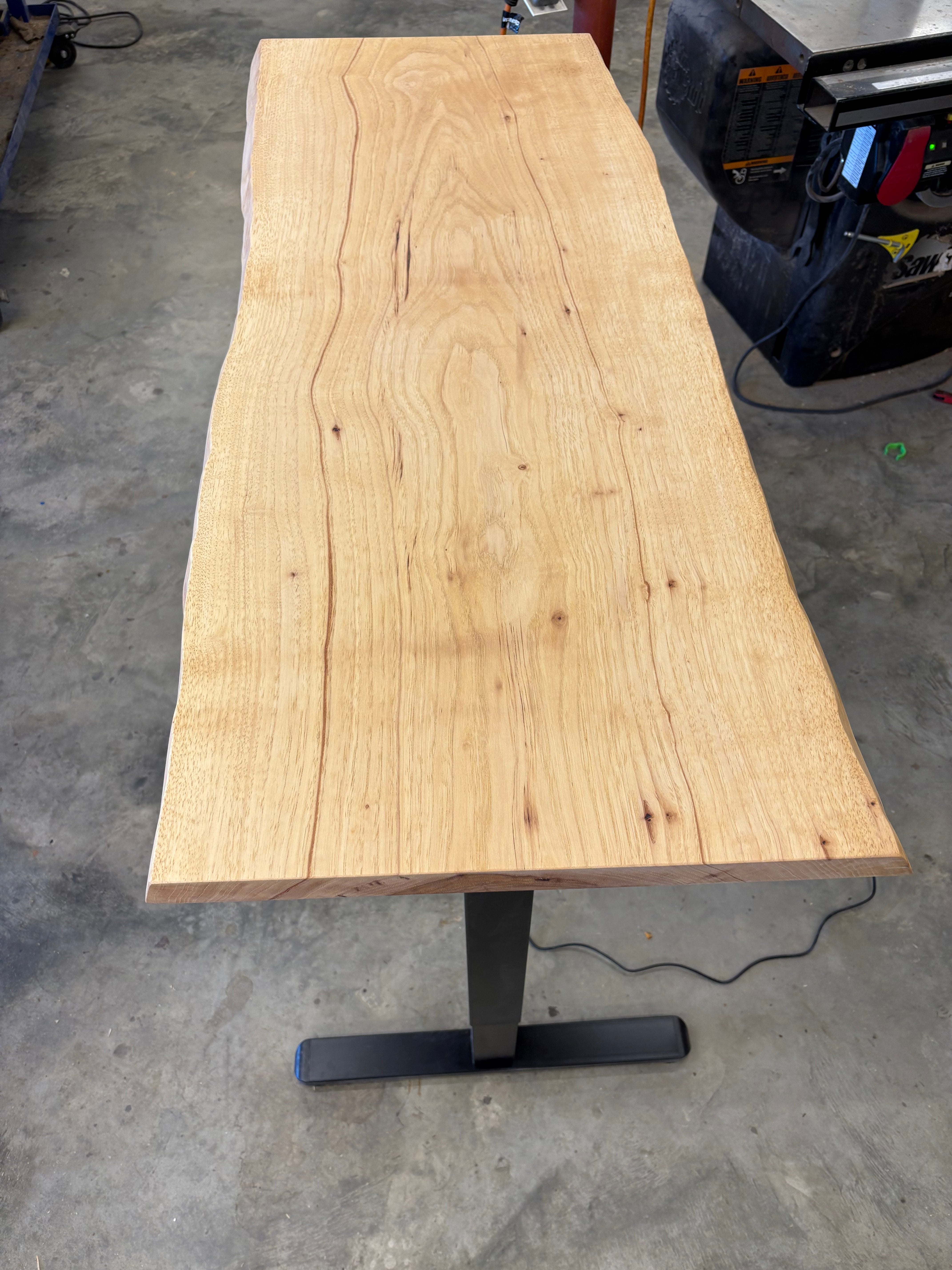 Adjustable height sit/stand pecan desk with wooden finish and metal legs