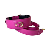 Fuchsia pink Italian leather dog collar with gold metal buckle paired with matching leash, shown coiled on a white background.