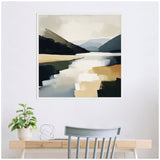 Abstract framed canvas depicting a mountain lake scene with layered shades of blue, beige, and gray, hung above a light wood desk with a green plant and a gray chair.
