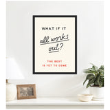 Framed motivational poster with black, red, and cursive text reading 'What if it all works out? The best is yet to come' on a cream background above a white shelf with lamp, photo frame, and plant.