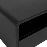 Close-up of a matte black side table corner with smooth, rounded edges and a visible open shelf below the top surface.