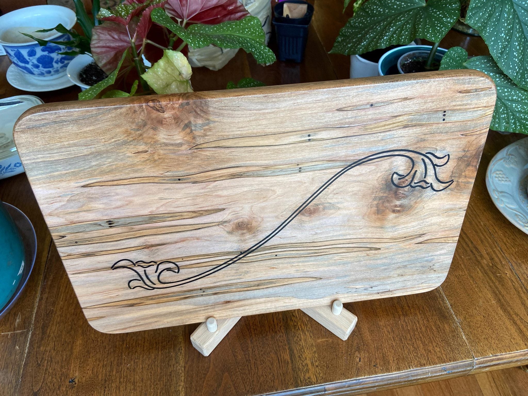 Ambrosia Maple charcuterie board with flower scroll resin inlay by Fitzgerald Custom Woodcraft