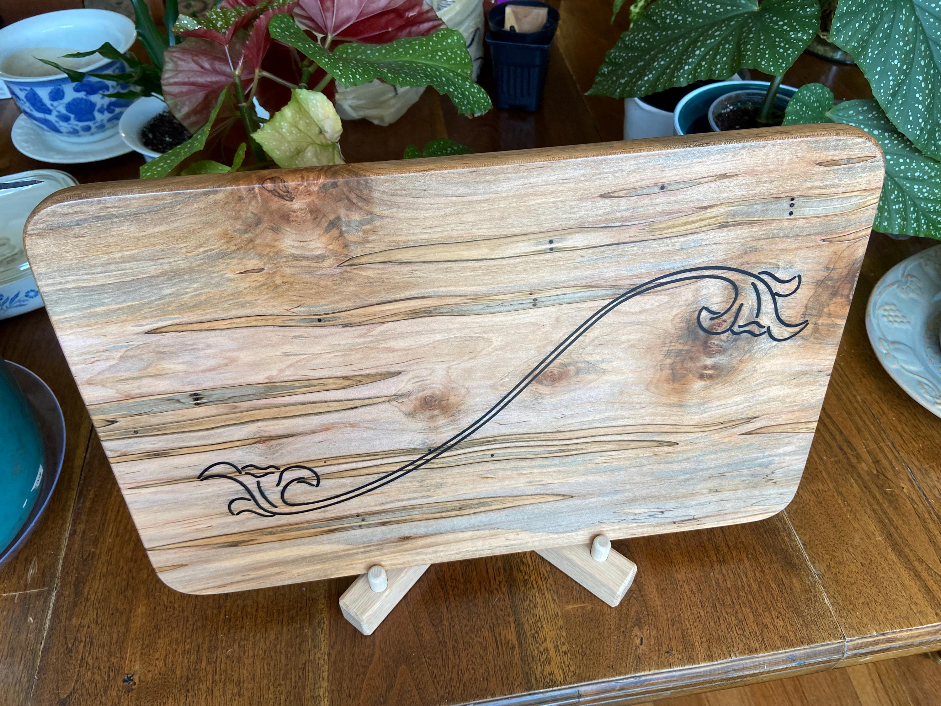 Ambrosia Maple charcuterie board with flower scroll resin inlay by Fitzgerald Custom Woodcraft