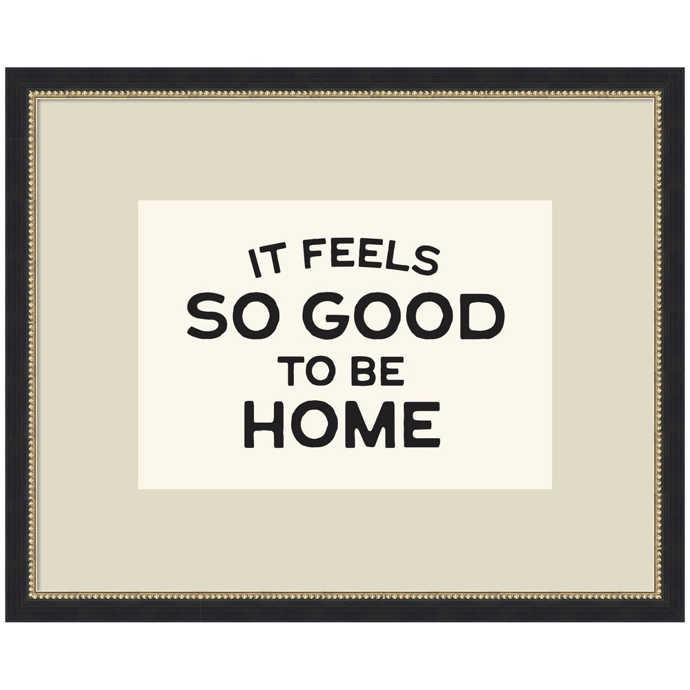 Framed black and white typography art print reading 'It Feels So Good to be Home' by Lucky Guava