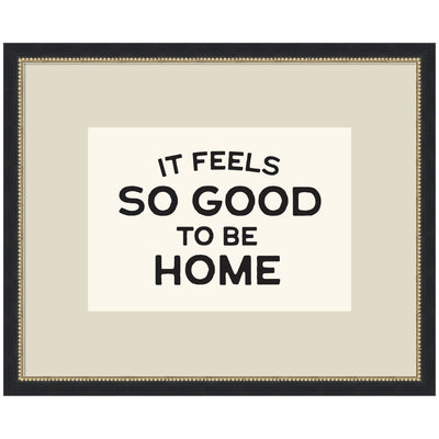 Framed black and white typography art print reading 'It Feels So Good to be Home' by Lucky Guava