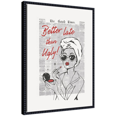 Framed canvas wall art titled 'Better Late Than Ugly Newspapers' by Honey Island Studio, showing a chic woman applying makeup over a vintage newspaper background in a black ornate frame.