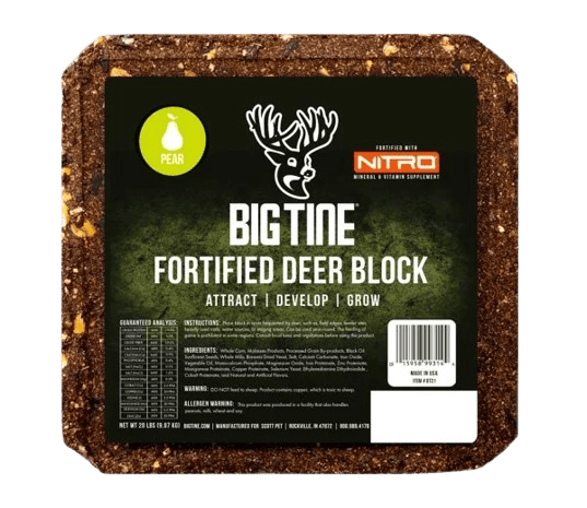 Square dark brown fortified deer block speckled with lighter bits, labeled Big Tine Fortified Deer Block with pear flavor and Nitro mineral supplement branding.